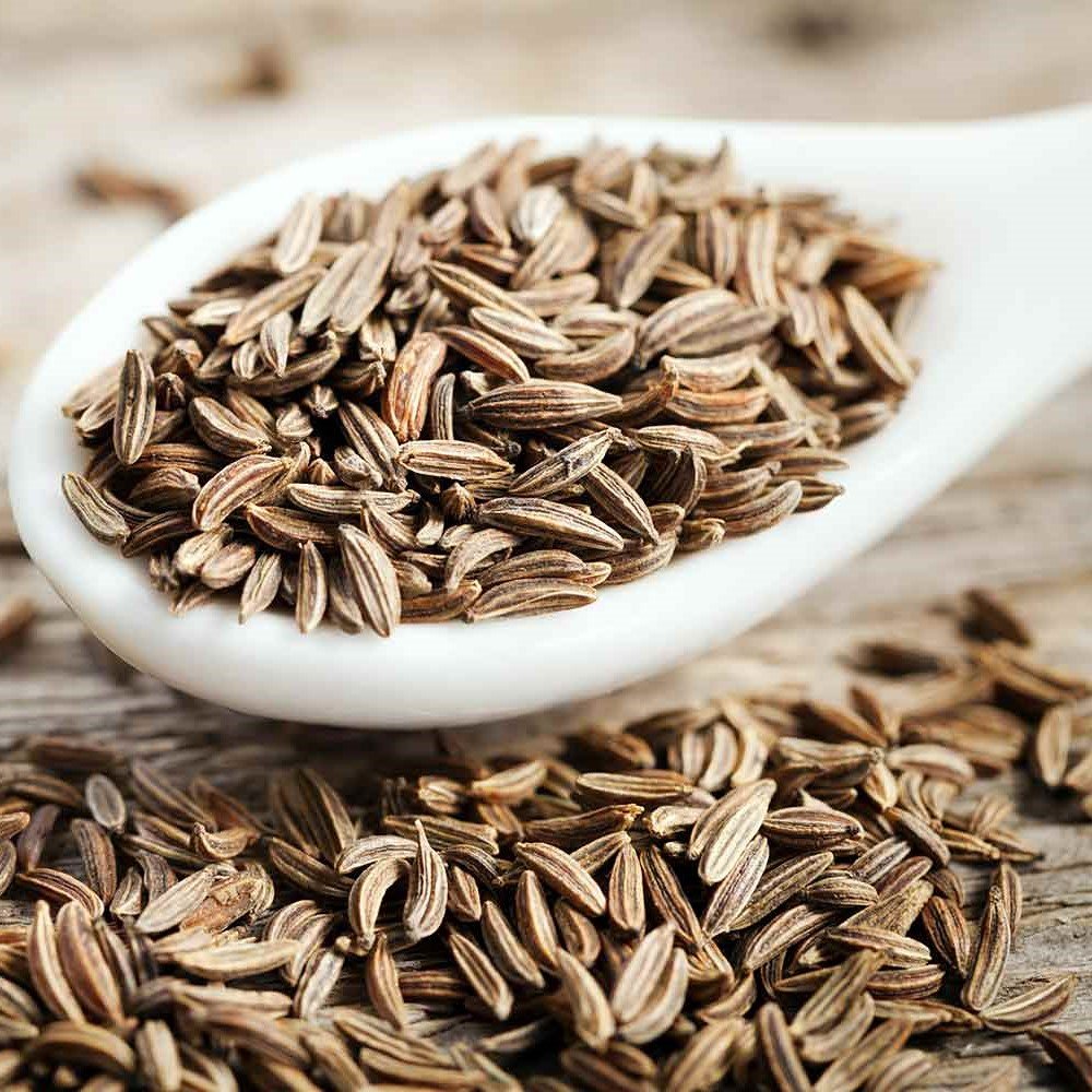 Close-up of bold, machine-cleaned Cumin Seeds (Jeera) texture at Jalaram Food Products.