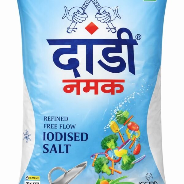 A packet of Dandi Iodized Salt displayed alongside bulk grocery supplies at Jalaram Food Products, Ahmedabad.